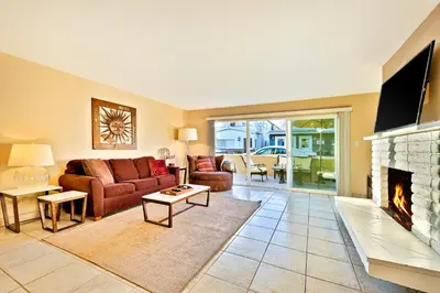 a living room with a couch and a fireplace at Newport Beach Simplicity in Newport Beach