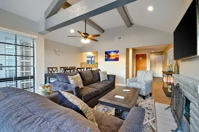 a living room with a couch and a table at Perfect Newport Beach Location With Balcony Spa II in Newport Beach