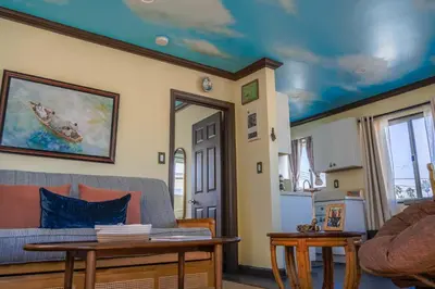 a living room with a couch and a table at Catch of the Day Pet-Friendly El Pescador 1 Block from the Beach in San Diego