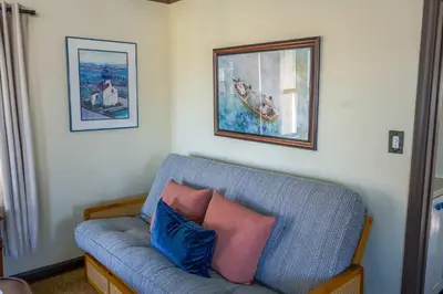 a blue couch with two pillows in a living room at Catch of the Day Pet-Friendly El Pescador 1 Block from the Beach in San Diego