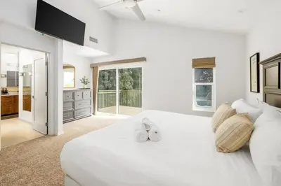 a white bedroom with a large white bed with shoes on it at Hot Tub Pool 3Bed Home in Encinitas