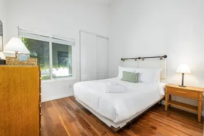 a white bedroom with a large bed and a window at Hot Tub Pool 3Bed Home in Encinitas