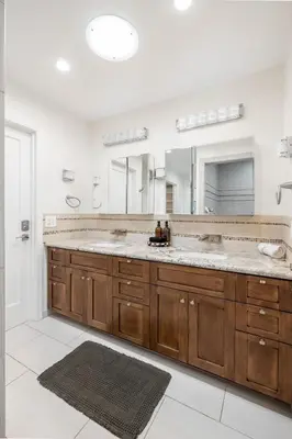 a bathroom with a large sink and two mirrors at Hot Tub Pool 3Bed Home in Encinitas
