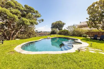 a swimming pool in the middle of a grass field at Hot Tub Pool 3Bed Home in Encinitas