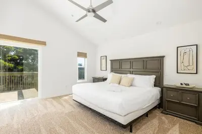 a bedroom with a white bed and a ceiling fan at Hot Tub Pool 3Bed Home in Encinitas