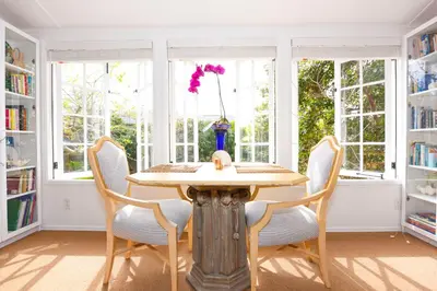 a dining room with a wooden table and chairs at Charming Garden Cottage with Full Kitchen Walk to La Jolla Village & Beaches in San Diego