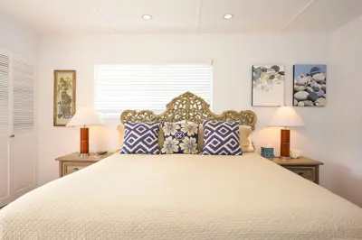 a bedroom with a large bed with two lamps at Charming Garden Cottage with Full Kitchen Walk to La Jolla Village & Beaches in San Diego