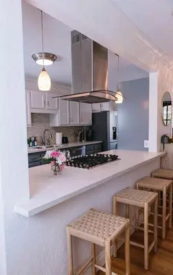 a kitchen with a counter with stools and a stove at Travelers Dream Home SDSU Hot Tub Pool Table in San Diego
