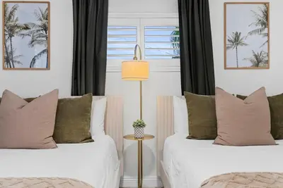 two beds sitting next to each other in a bedroom at Travelers Dream Home SDSU Hot Tub Pool Table in San Diego