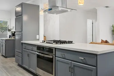 a kitchen with a stove and a counter top at Travelers Dream Home SDSU Hot Tub Pool Table in San Diego