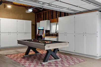 a ping pong table in a room with white cabinets at Travelers Dream Home SDSU Hot Tub Pool Table in San Diego