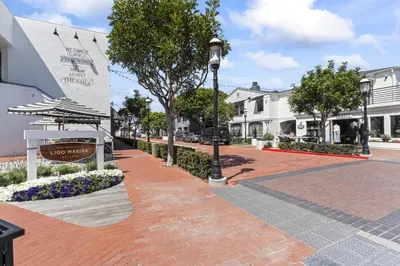 a street with a street light on a brick sidewalk at Steps to Lido Village and the Marina Heart of Lido Island 2 Car Garage in Newport Beach