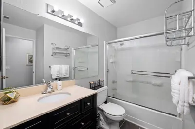 a bathroom with a shower and a toilet and a sink at Lux Modern Pet Friendly | Pool | Hot Tub | Tennis in Oceanside