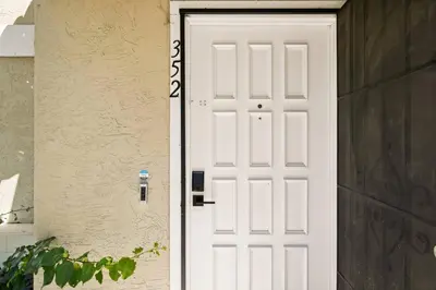 a white door on the side of a building at Lux Modern Pet Friendly | Pool | Hot Tub | Tennis in Oceanside