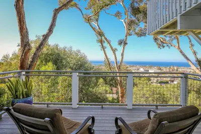 a deck with two chairs and a view of the ocean at Seaview craftsman with Amazing views in San Diego
