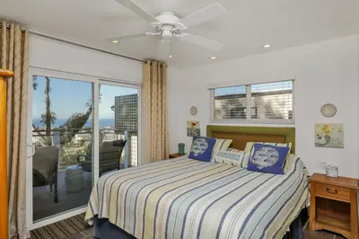 a bedroom with a bed and a balcony at Seaview craftsman with Amazing views in San Diego