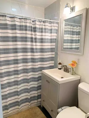 a bathroom with a shower curtain and a sink at Coastal Chill San Diego - Heated Pool - XXL Spa - Mini Golf - Gourmet Kitchen in San Diego