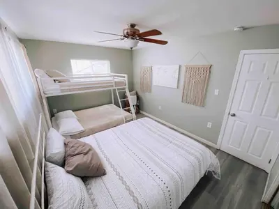 a bedroom with two bunk beds and a ceiling fan at Coastal Chill San Diego - Heated Pool - XXL Spa - Mini Golf - Gourmet Kitchen in San Diego