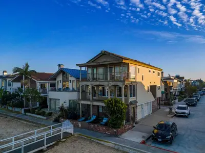 a house with a car parked in front of it at Bay Breeze in Newport Beach