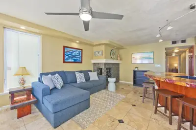 a living room with a blue couch and a bar at Bay Breeze in Newport Beach