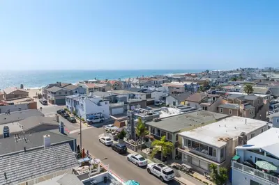 an aerial view of a city with the ocean at Salt & Sand I in Newport Beach