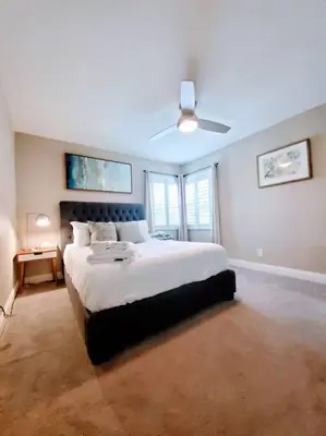 a bedroom with a large bed with a ceiling fan at Heart of San Diego-Walk Score 82-Backyard -BBQ-HBO in San Diego