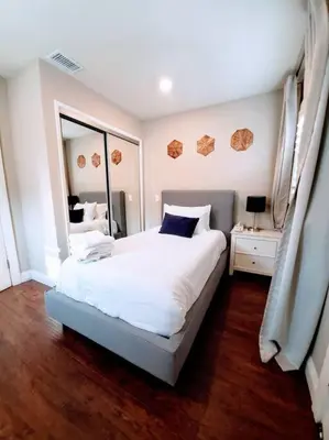 a bedroom with a large white bed and a mirror at Heart of San Diego-Walk Score 82-Backyard -BBQ-HBO in San Diego