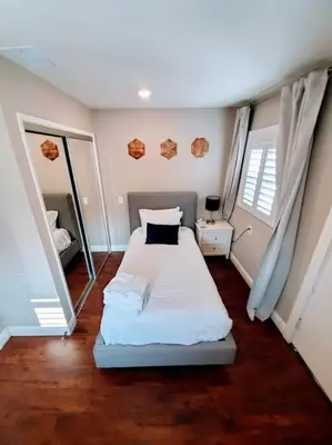 a bedroom with a bed and two mirrors in it at Heart of San Diego-Walk Score 82-Backyard -BBQ-HBO in San Diego