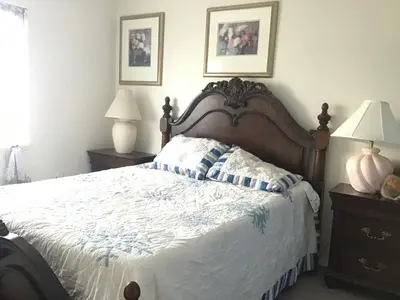 a bedroom with a large bed and two night stands at Guest Suites in High Tech Park in Rancho Bernardo