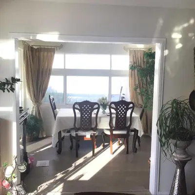 a dining room with a table and chairs and a window at Guest Suites in High Tech Park in Rancho Bernardo