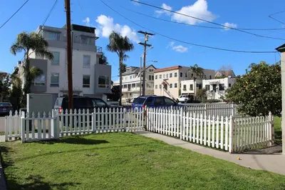 a white picket fence in front of a yard at Sweet n Cozy Cottage near Little Italy & Gaslamp in San Diego