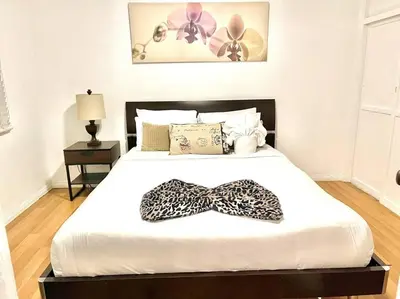 a bedroom with a bed with a bow tie on it at Cozy Urban Cottage in San Diego