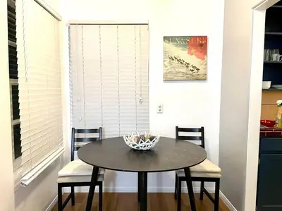 a dining room table with two chairs and a bowl on it at Cozy Urban Cottage in San Diego