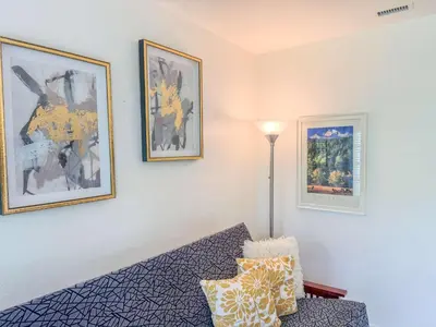 a room with a bed and pictures on the wall at Orange Grove Cottage in Bankers Hill in San Diego