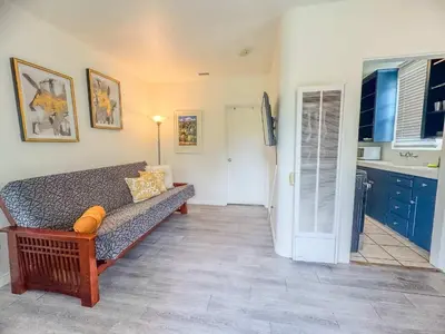 a living room with a couch and a kitchen at Orange Grove Cottage in Bankers Hill in San Diego