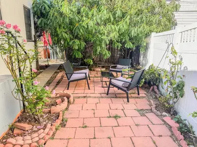 a patio with two chairs and a table and some plants at Amazing Cottage - near Little Italy Gaslamp in San Diego