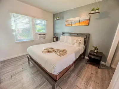 a bedroom with a bed with a scarf on it at Amazing Cottage - near Little Italy Gaslamp in San Diego