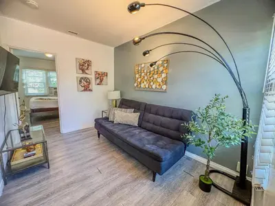 a living room with a couch and a table at Amazing Cottage - near Little Italy Gaslamp in San Diego