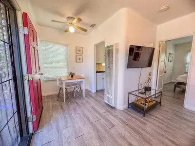 a living room with a table and a ceiling fan at Amazing Cottage - near Little Italy Gaslamp in San Diego