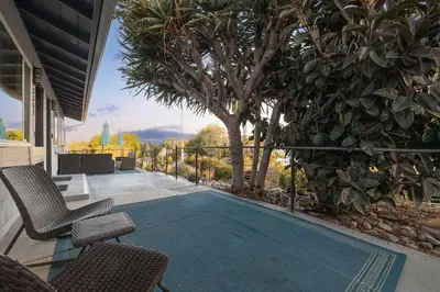 a swimming pool with two chairs and a tree at Central Location Balboa Park Villa in San Diego