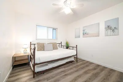 a bedroom with a bed and a ceiling fan at Central Location Balboa Park Villa in San Diego