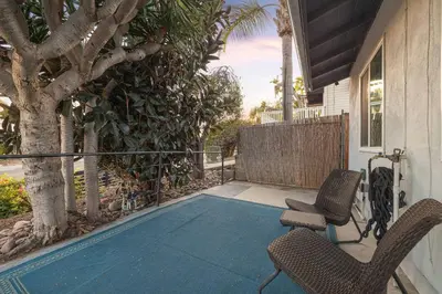 a patio with two chairs and a tree on a house at Central Location Balboa Park Villa in San Diego