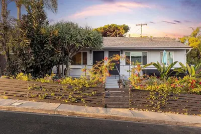 a house with a wooden fence in front of it at Central Location Balboa Park Villa in San Diego