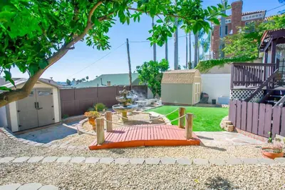 an orange bench sitting in the middle of a yard at Great Views Studio apartment near Little Italy in San Diego