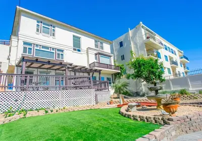 an apartment building with a fountain in front of a yard at Great Views Studio apartment near Little Italy in San Diego