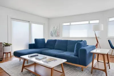 a blue couch in a living room with a table at Lovely Laguna Oceanside Gem! in Laguna Beach