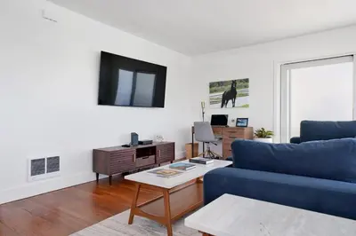 a living room with a blue couch and a table at Lovely Laguna Oceanside Gem! in Laguna Beach