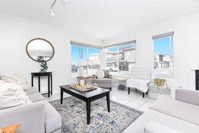a living room with a couch and a table at Luxury 4Br W Ac, Rooftop Deck, And Stunning Ocean Views By Beachview Rentals in Newport Beach