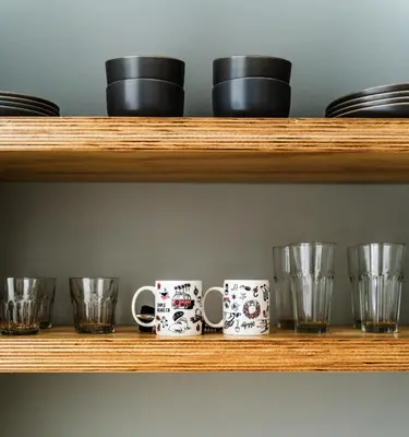 a row of mugs and glasses on a shelf at Simple La Jolla Epic bungalow #1 in San Diego