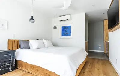 a bedroom with a bed and a flat screen tv at Simple La Jolla Epic bungalow #1 in San Diego